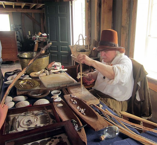 old man in white shirt with wooden rod