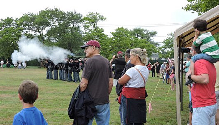 Crowd watching skirmish at civil war reenactment