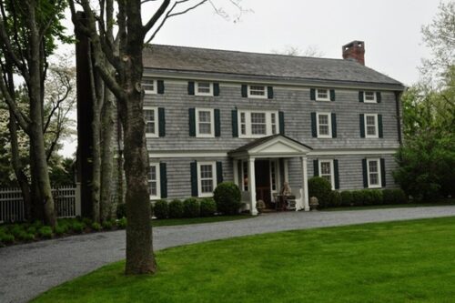 historic stage coach inn building covered in grey shake wood