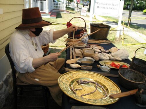 a woman making wampum